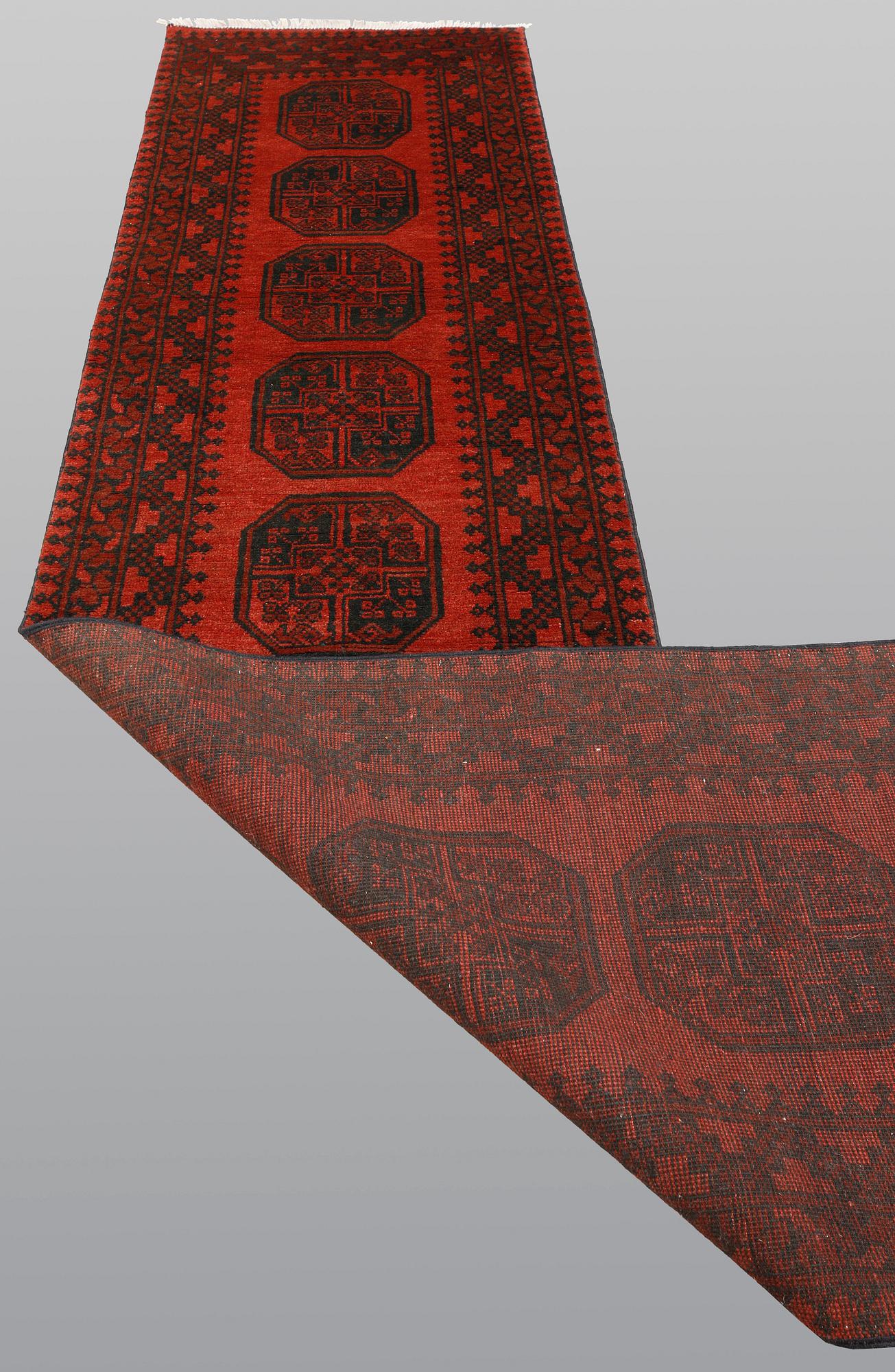 An Afghan runner, ca 383 x 78 cm.