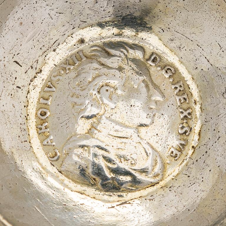 A silver tumbler with inset Swedish coin dated 1713.