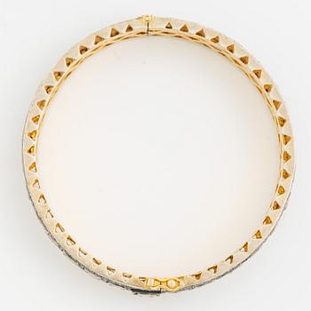 A faceted diamond bangle.