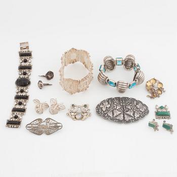 A silver belt buckle, three bracelets, two pairs of earrings, a pair of cuff-links and a brooch.