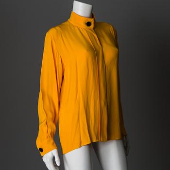 A blouse by Yves Saint Laurent, size 42 (FR).