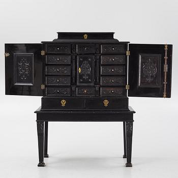 A South-German Baroque ebonized collector's cabinet on stand, circa 1700.