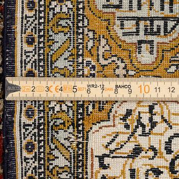 A silk Qum rug, c. 172 x 105 cm.