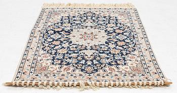 A Nain rug, part silk, c. 128 x 82 cm.