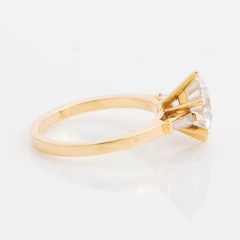 An 18K gold ring set with a round brilliant-cut diamond weight 3.30 cts quality E vs2.