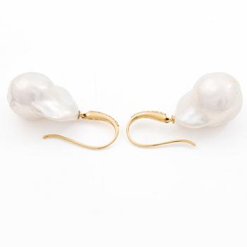 A pair of earrings with cultured baroque-shaped freshwater pearls and round brilliant-cut diamonds.