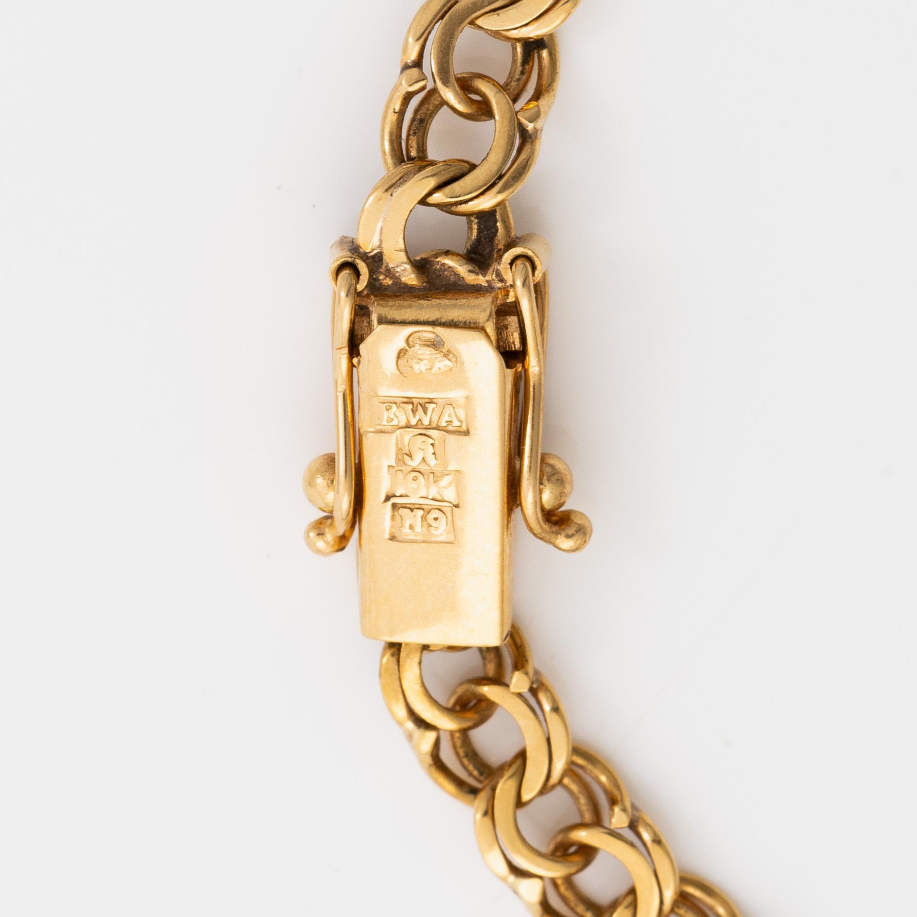 Bracelet 18K gold with five charms.