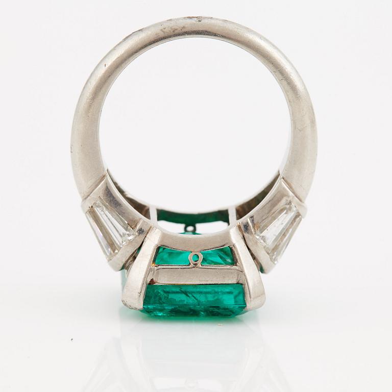 A columbian emerald and tapered cut diamond ring.