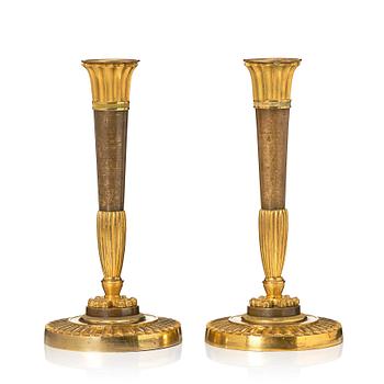 148. A pair of Empire candelsticks.