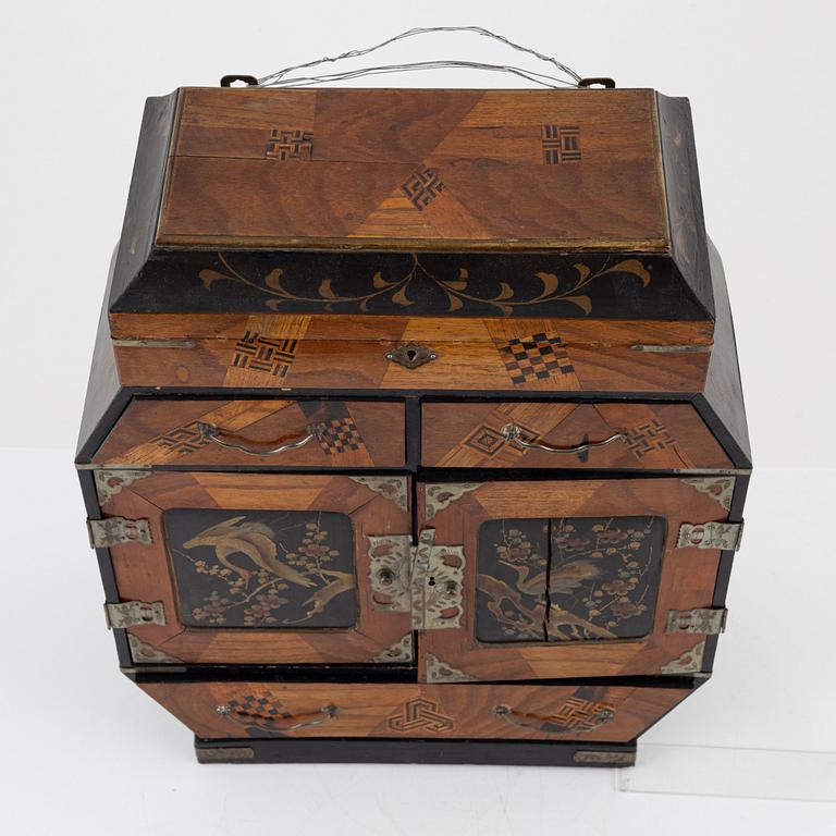 A Japenese partially lacquered hanging cabinet, early 20th century.