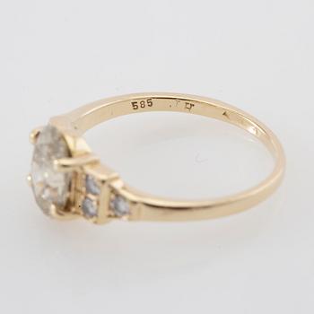 Ring 14K gold with an oval faceted diamond approximately 1.23 ct and round brilliant-cut diamonds.