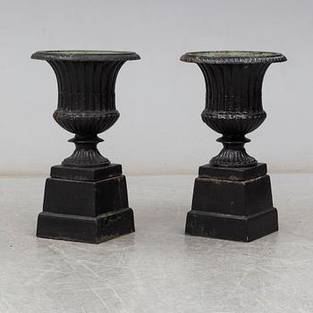 A pair of 20th century cast iron urns.