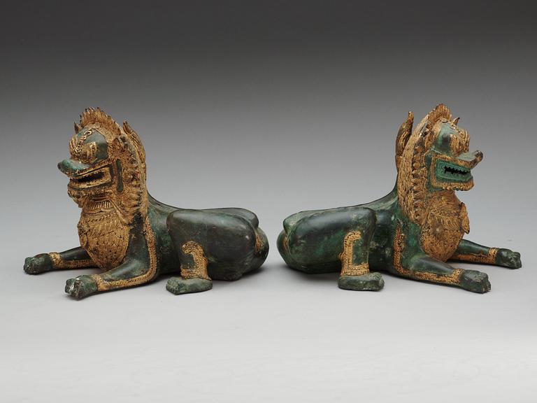 A pair of Burmese/Thai gilt bronze figures of buddhist lions, late 19th Century.