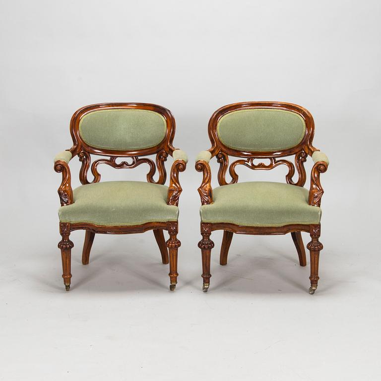 A pair of Russian armchairs and a table, late 19th century.