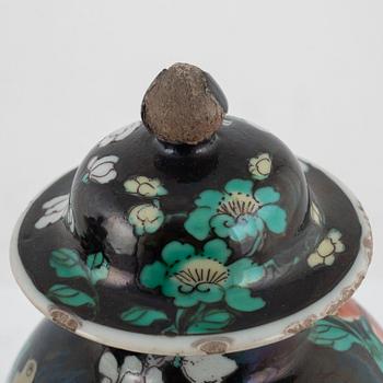 A pair of Famille Noir lidded urns, China, 20th century.