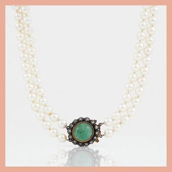 1166. A two-strand cultured pearl necklace. Clasp with cabochon-cut emerald and rose-cut diamonds.