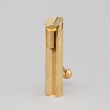 A brass candle holder by Pierre Forssell for Skultuna.