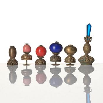 Two boxes with a mandarin's summer hat and black satin autumn hat and feather with six mandarin hat insignias.