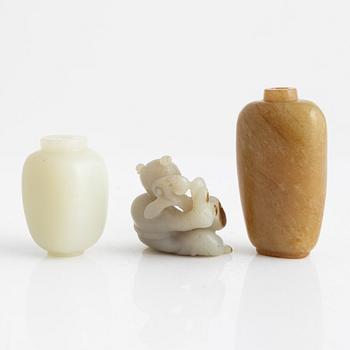 Two snuff bottles and a figurine, nefrit and green stone, China, 20th century.