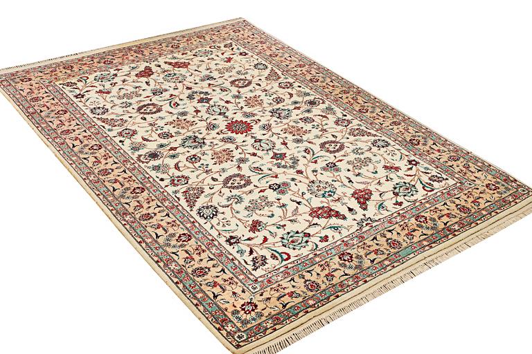 An oriental silk carpet, a. 280 x 185 cm.