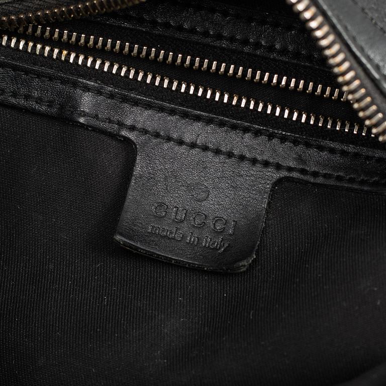 GUCCI, a leather horse-bit bag.