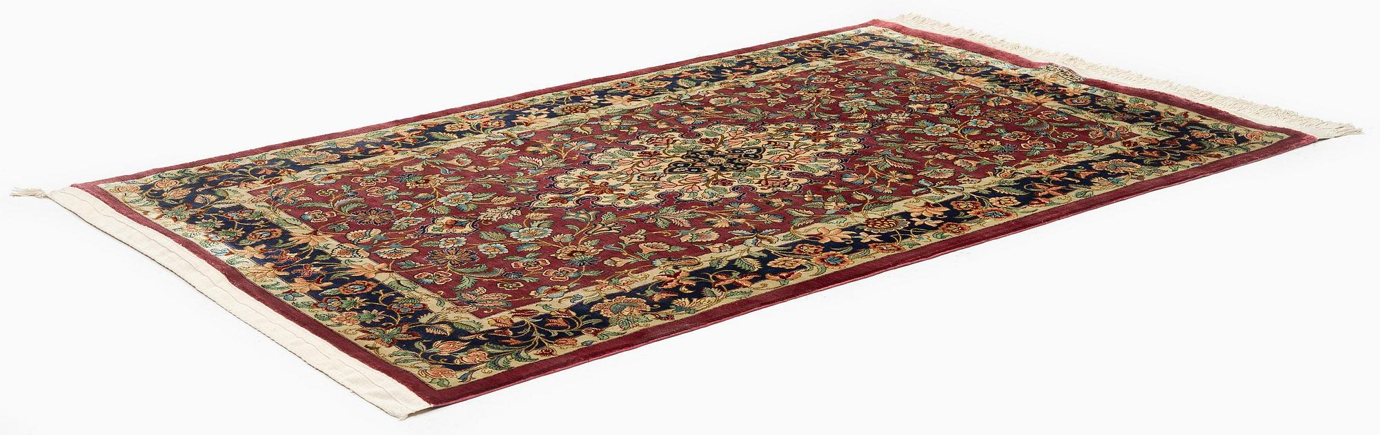 A silk Qum rug, Central Iran, signed, c. 170 x 101 cm.