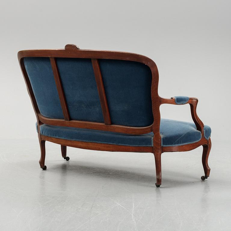 A sofa and a set of four chairs, Rococo revival, late 19th century.