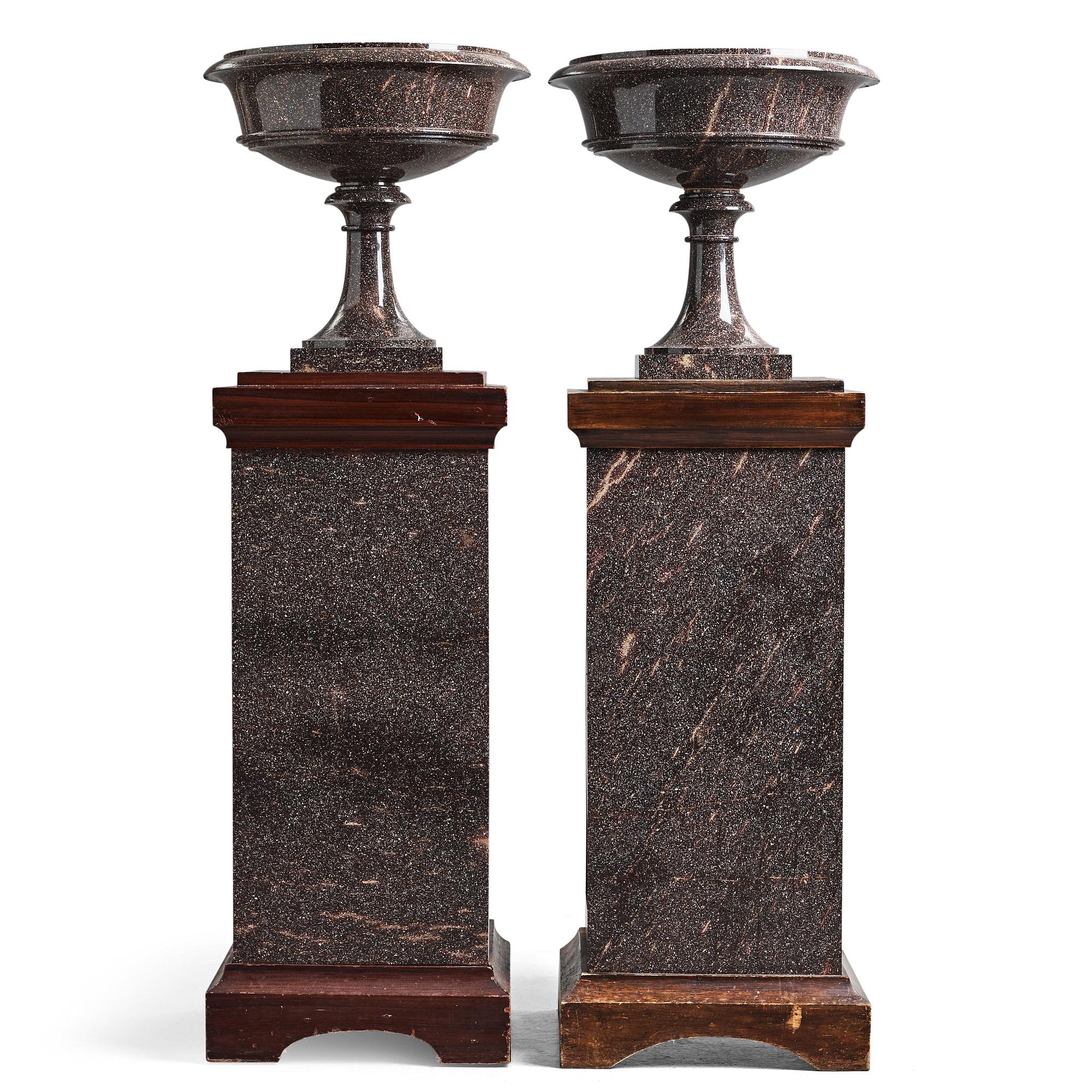 A pair of Swedish porpyry vases on wooden bases, Älvdalen, first half of the 19th century.