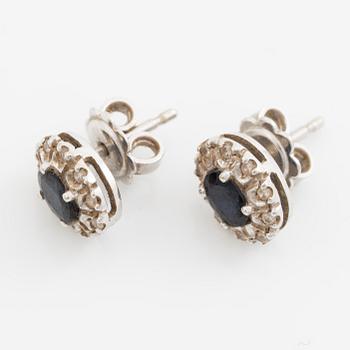 Earrings, a pair of 18K white gold set with dark sapphires and small brilliant-cut diamonds.