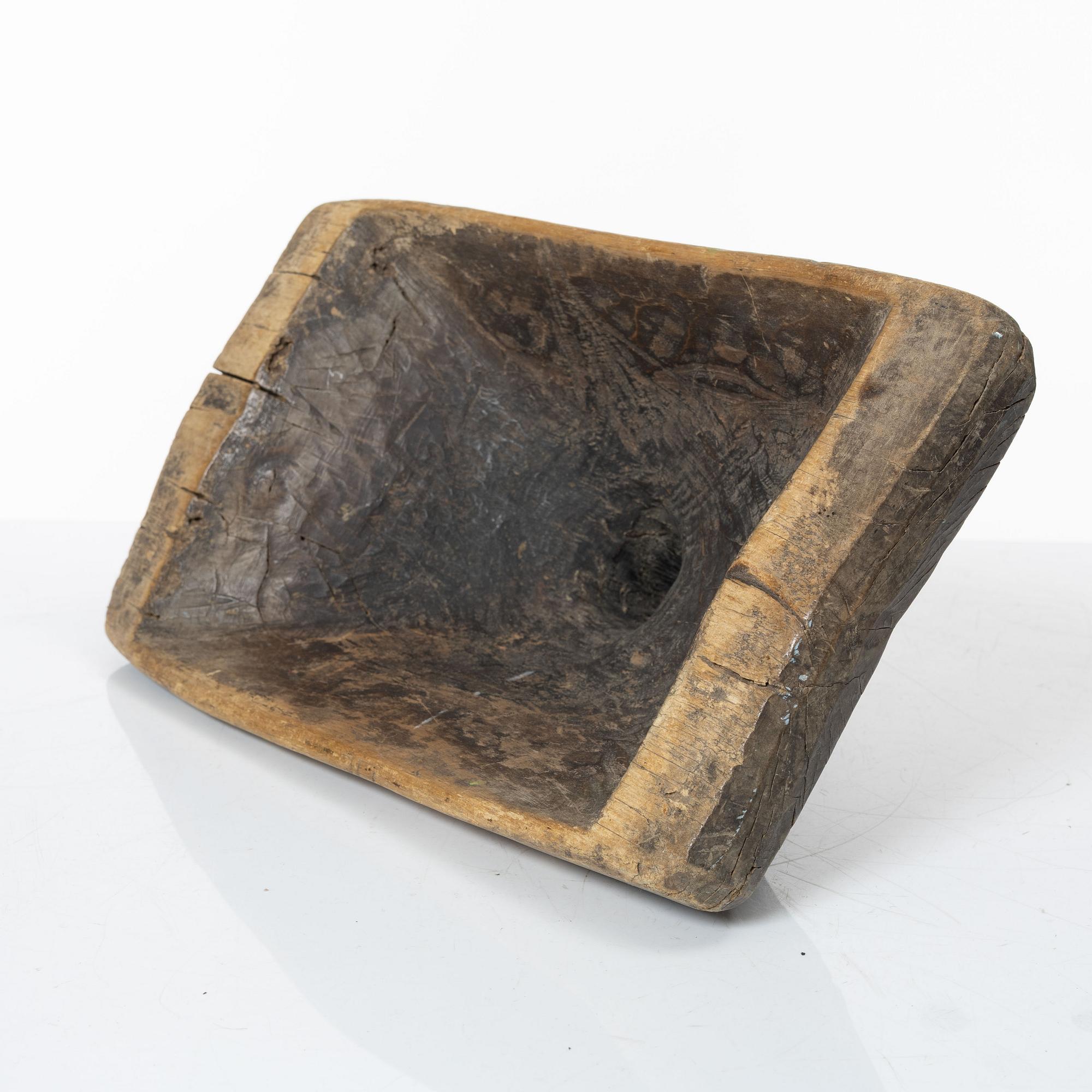 A Swedish carved wood milk funnel, dated 1687.