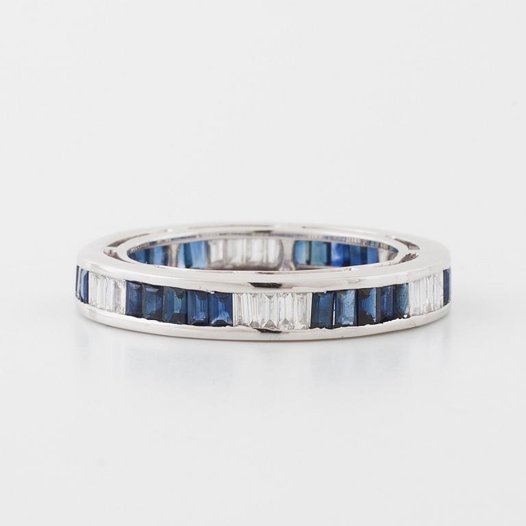 A sapphire and baguette cut diamond ring.