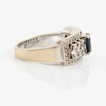 Ring with dark sapphire and brilliant-cut diamonds.