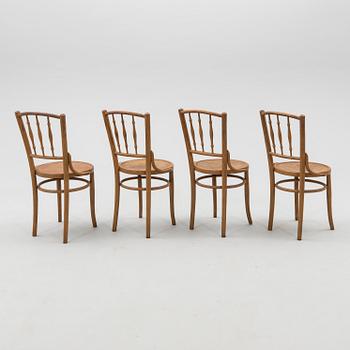 A set of four chairs from the first half of the 20th century.