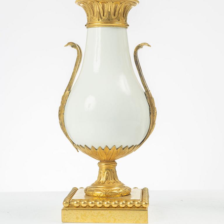 A pair of three light porcelain and gilt bronze three-branch Louis XV-style candelabra, mid 19th century.
