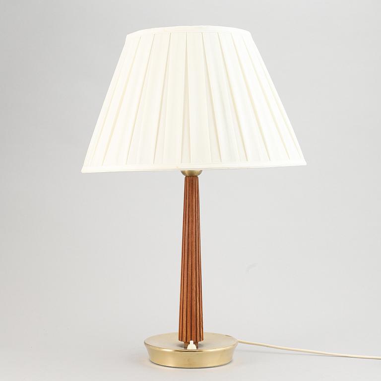 A brass and oak table light by Hans Bergström for ASEA, mid 20th Century.