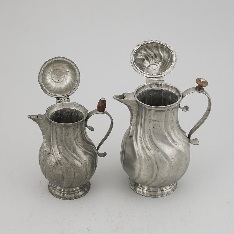 A pair of rococo style pewter coffee pots, from around year 1900.