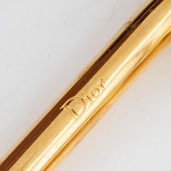 Christian Dior, a brown leather handbag.