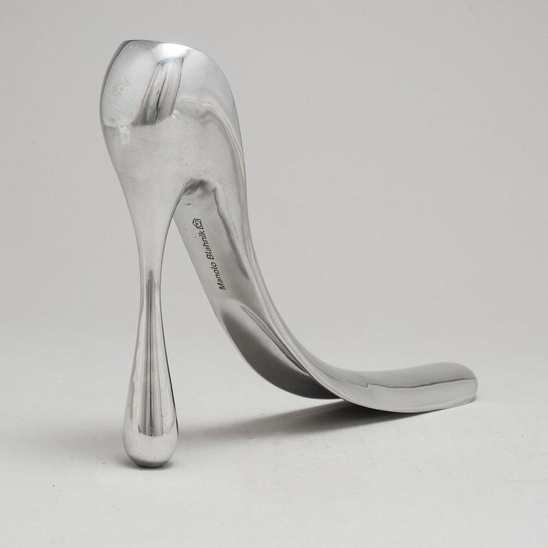 A metal shoe horn by Manolo Blahnik, with orignal box.