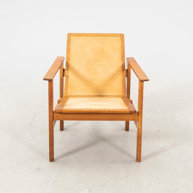 A stained wooden armchair later part of the 20th century.