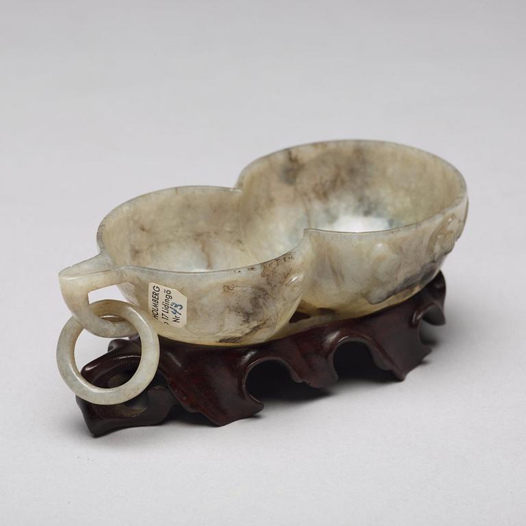 A Chinese group of three sculptured cups.