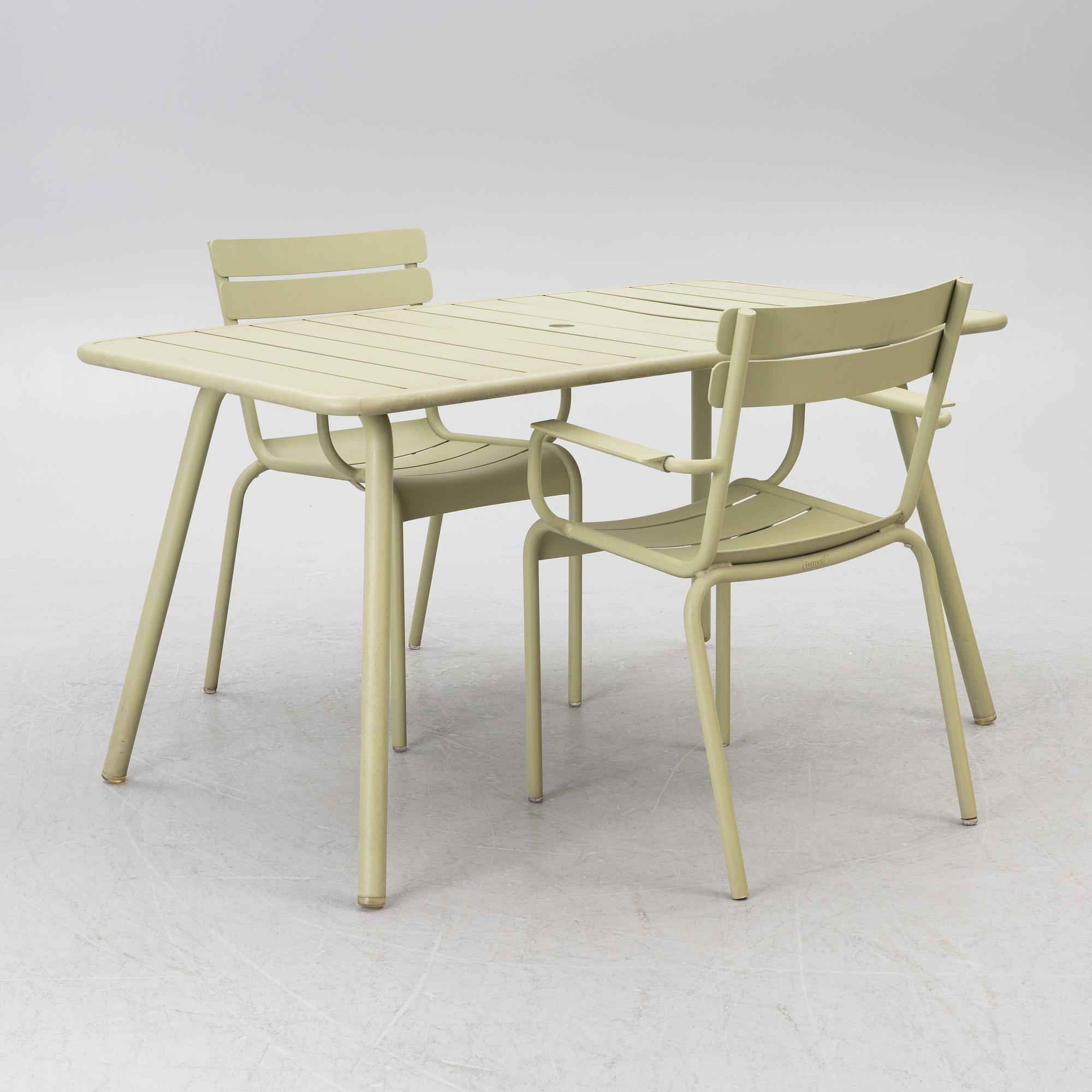 Frédéric Sofia, a table and two chairs for outdoor use, "Luxembourg" Fermob, France, 21st century.