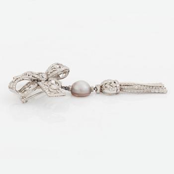 A platinum bow brooch set with old-cut diamonds with a detachable pearl and platinum pendant.