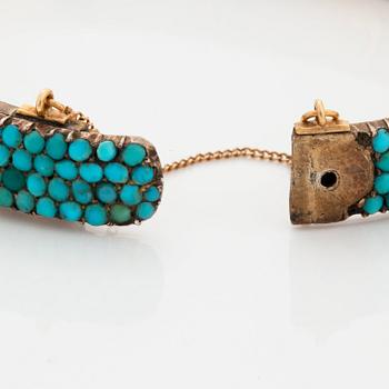 A silver and turquoise bracelet.