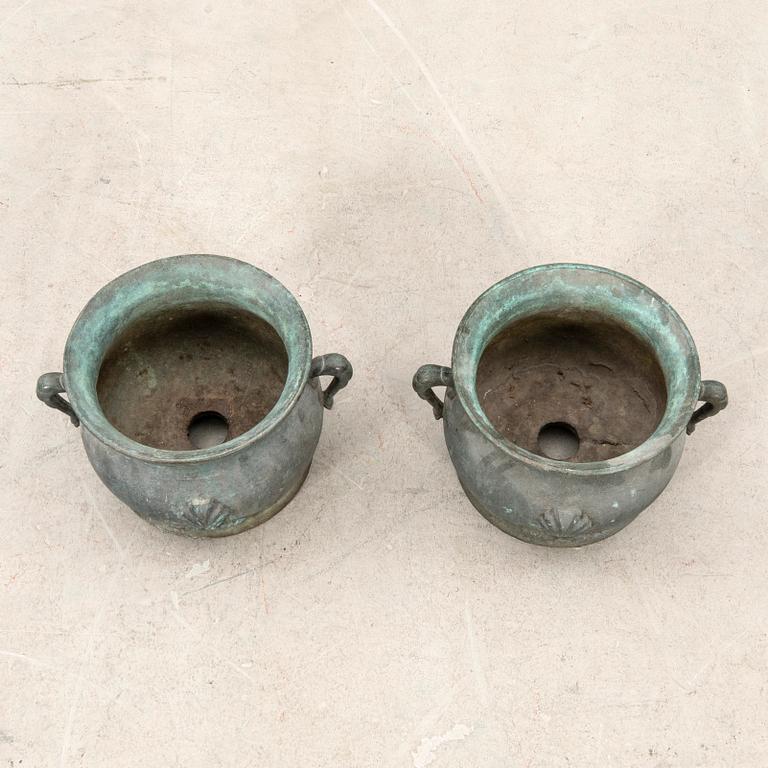 Outer casings/urns, a pair from the first half of the 20th century, cast iron.