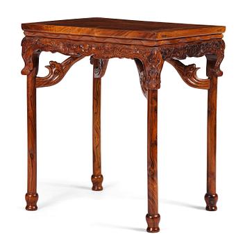 931. A Chinese huali square table with a lotus-leaf waist, 20th century.
