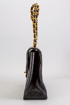 A Chanel maxi jumbo leather bag.