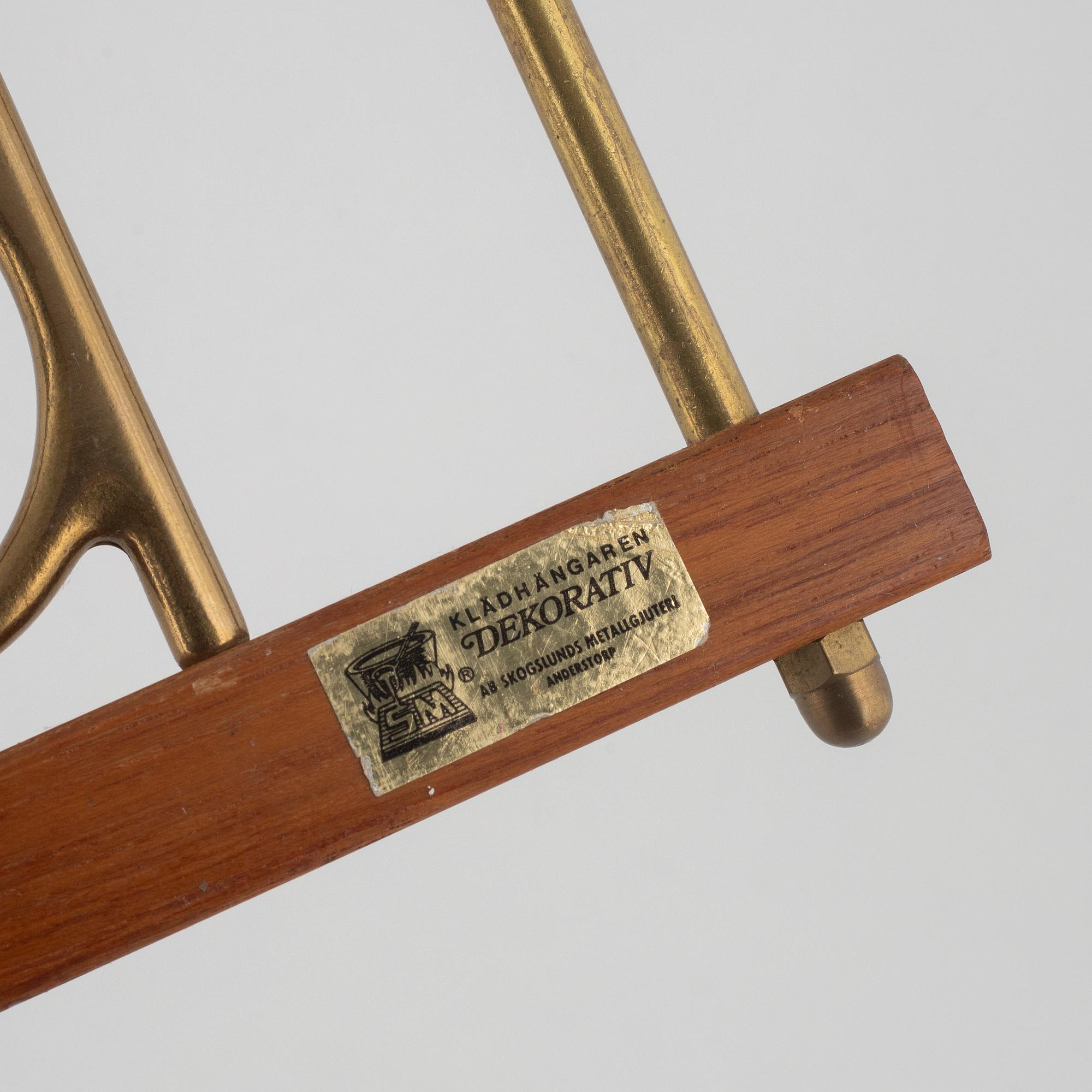 A pair of 'Dekorativ' coat hangers, Skoglunds metallgjuteri, Anderstorp, mid 20th Century.