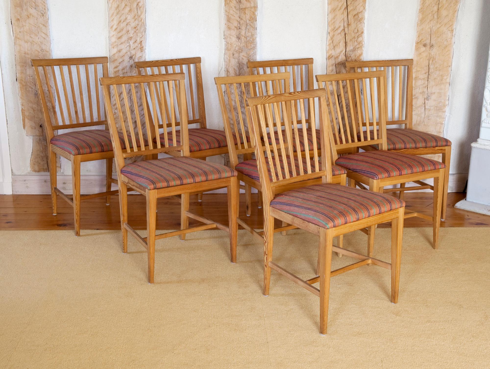 A SET OF EIGHT PINE CHAIRS,