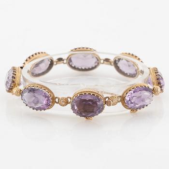 A set with a necklace, a bracelet, a brooch, and a ring.