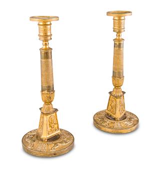 20. A PAIR OF CANDLESTICKS, gilt brass, early 19th Century.